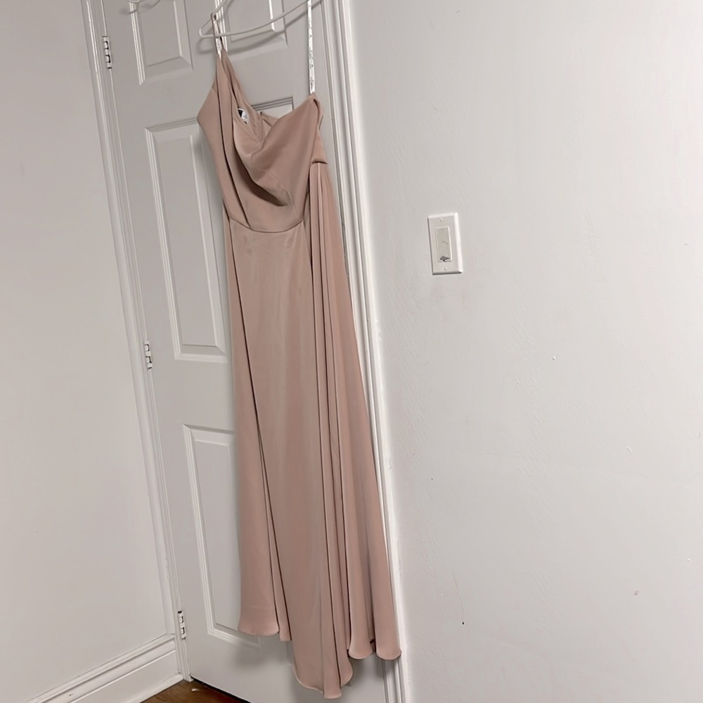 Pink, nude, one-shoulder, floor-length bridesmaid dress from David’s Bridal
